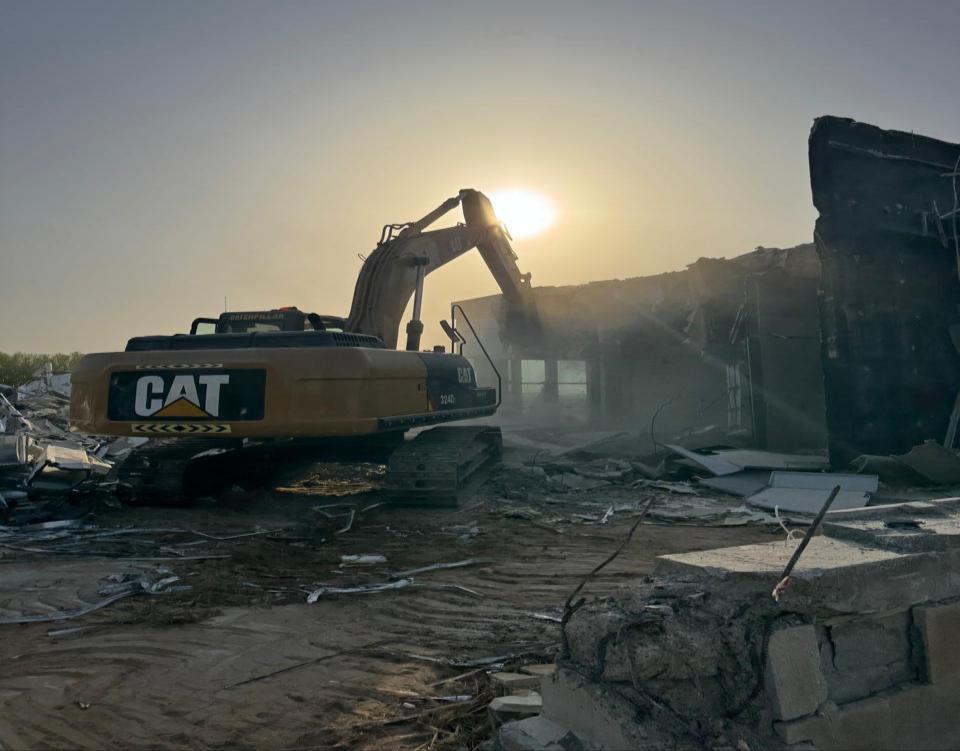 Heavy demolition excavator at an industrial site in Abu Dhabi